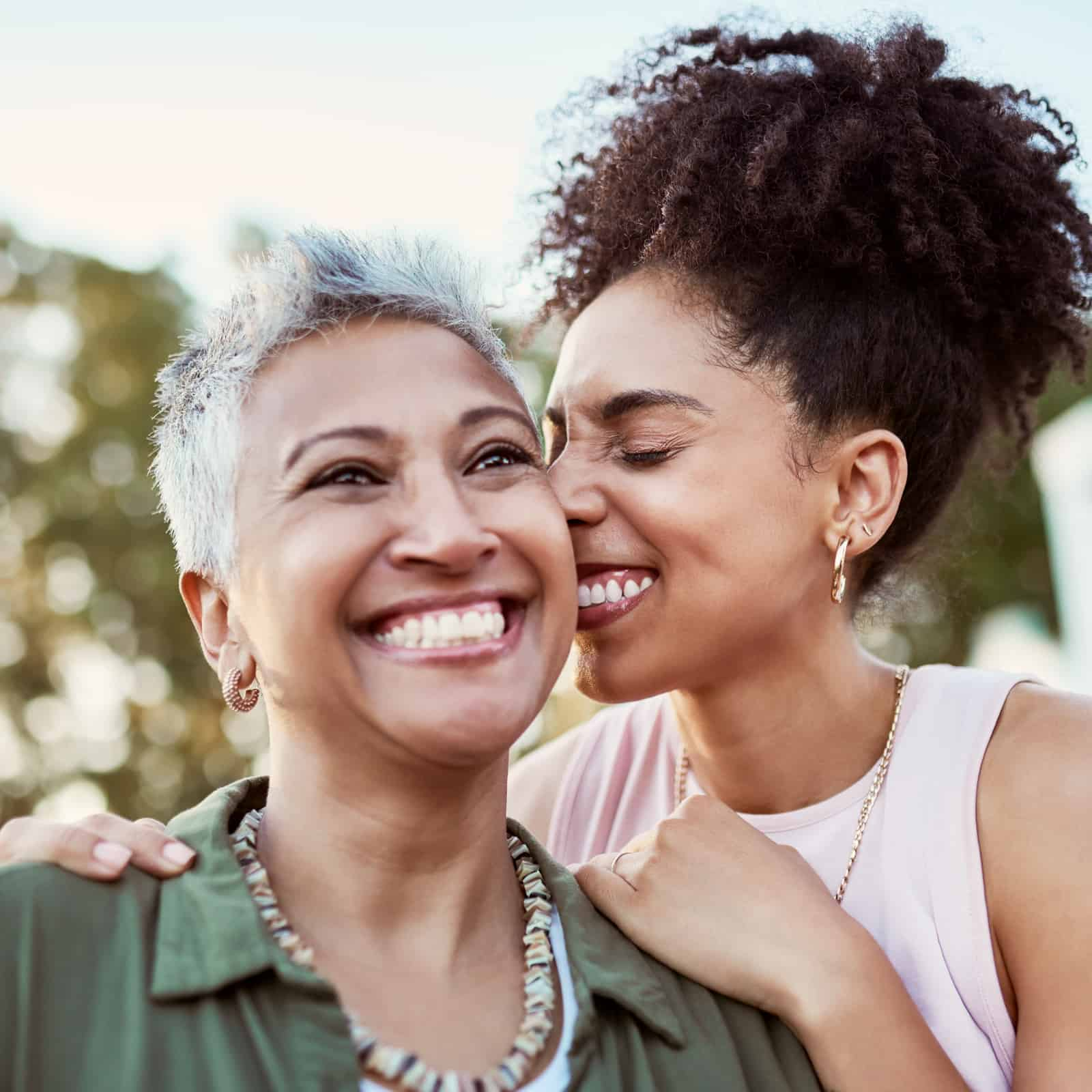 Two women close to each other smiling