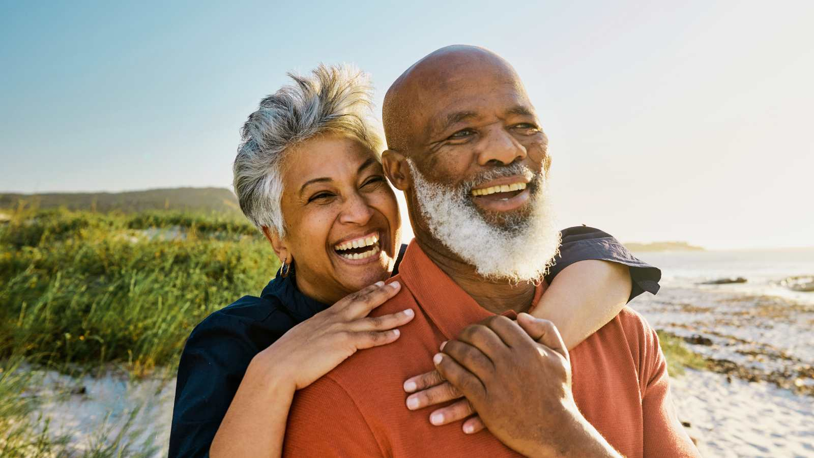 Older couple smiling together, outside