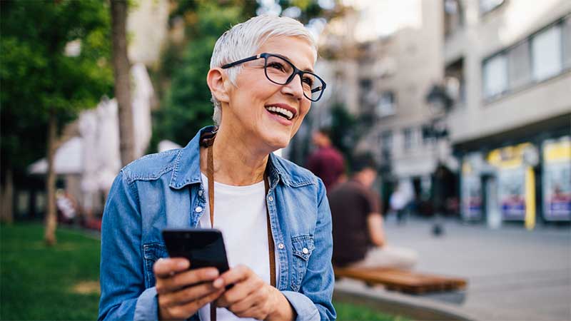 woman smiling holding phone