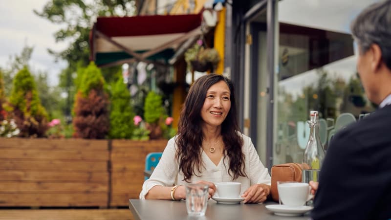 Two people in discussion over coffee