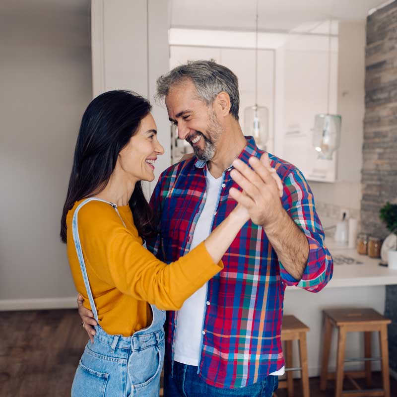 couple dancing together in kitchen