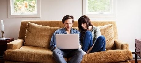 couple on sofa with laptop