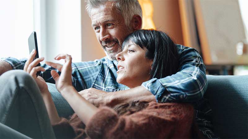 Couple browsing a mobile phone together