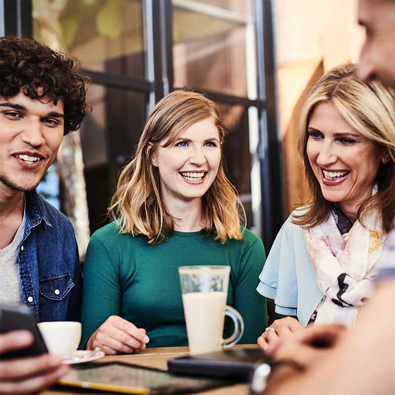 Group of people round a table drinking coffee