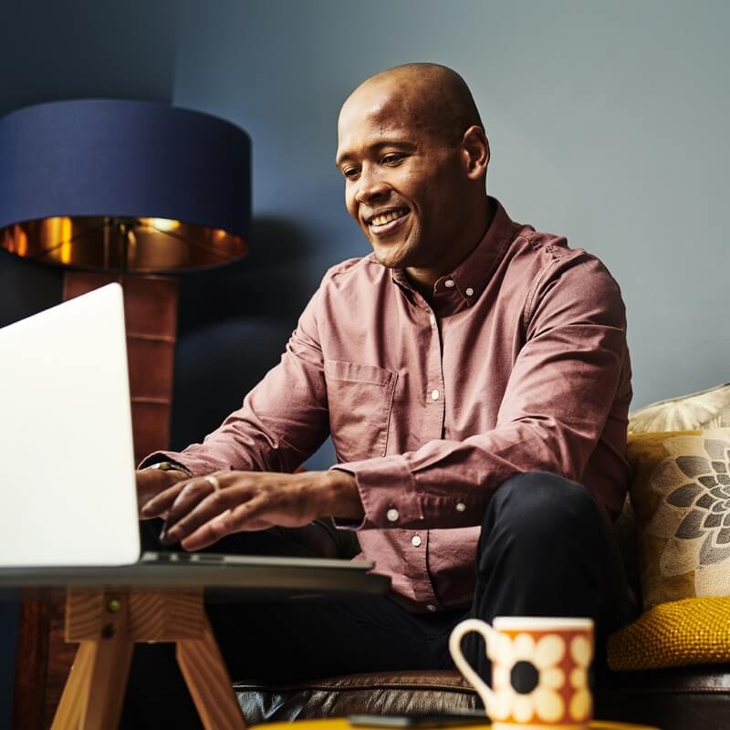 Smiling man working on laptop