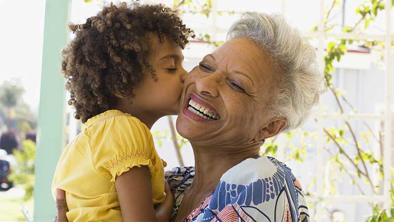 Young child in older woman's arms