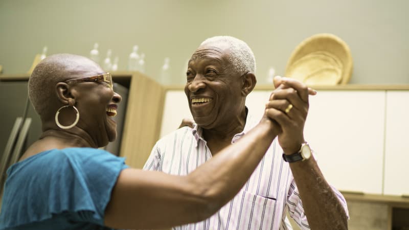 Older couple dancing in kitchen