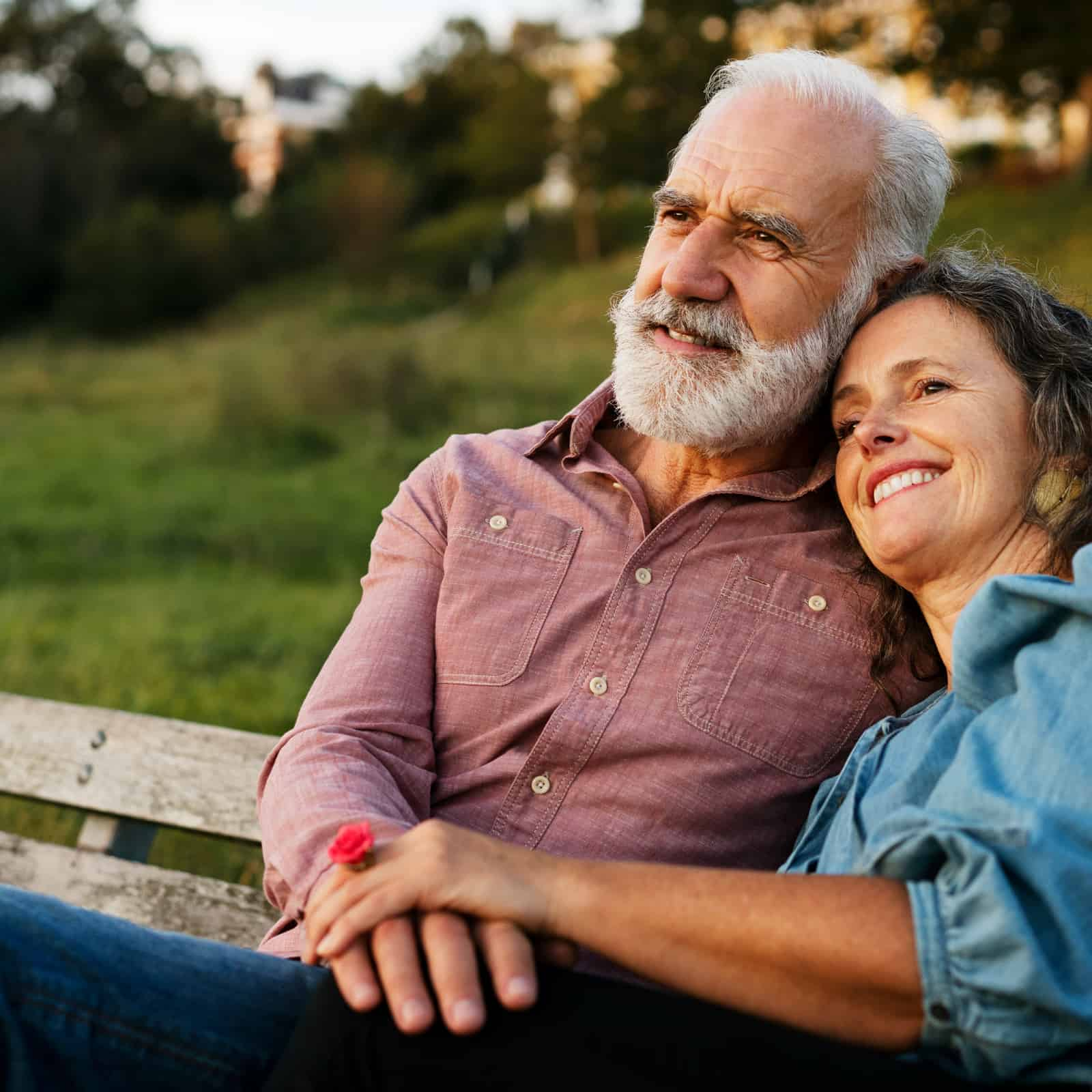 man and woman sat on a bench outside