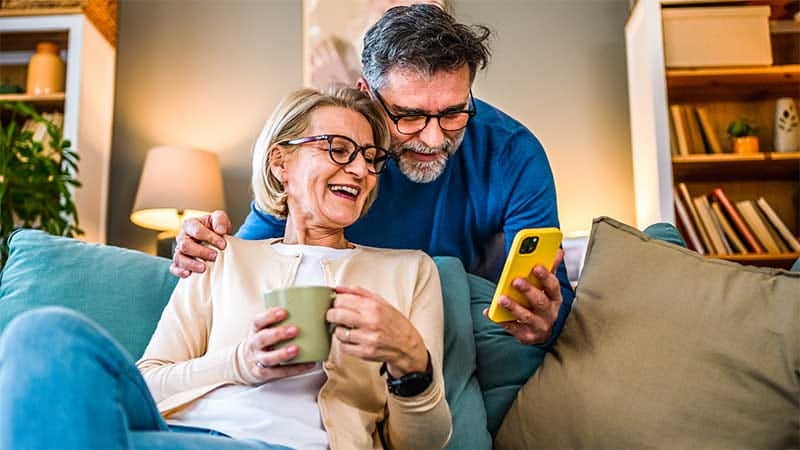 Couple looking at screen on a smart phone