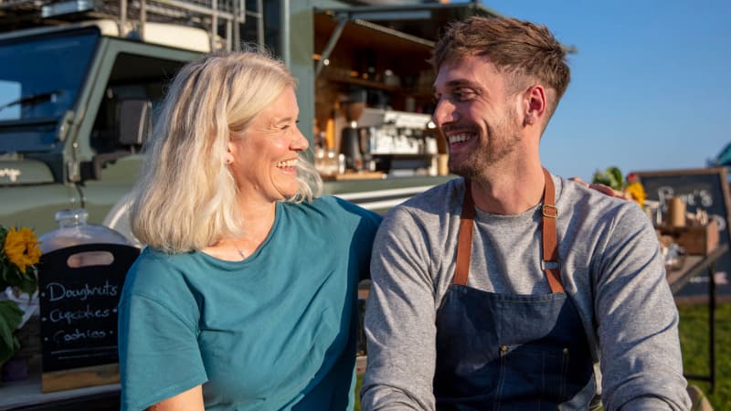 Mother and adult son smiling at each other