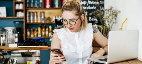 Woman with laptop and mobile phone