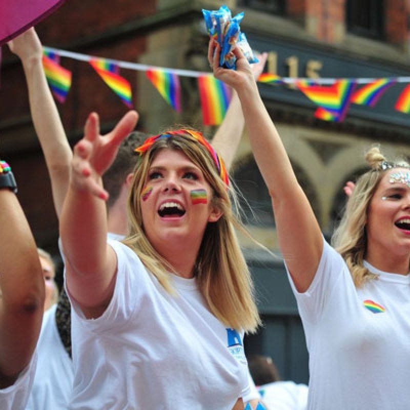 A Skipton employee at Leeds Pride Festival. Her cheeks are painted with rainbows.